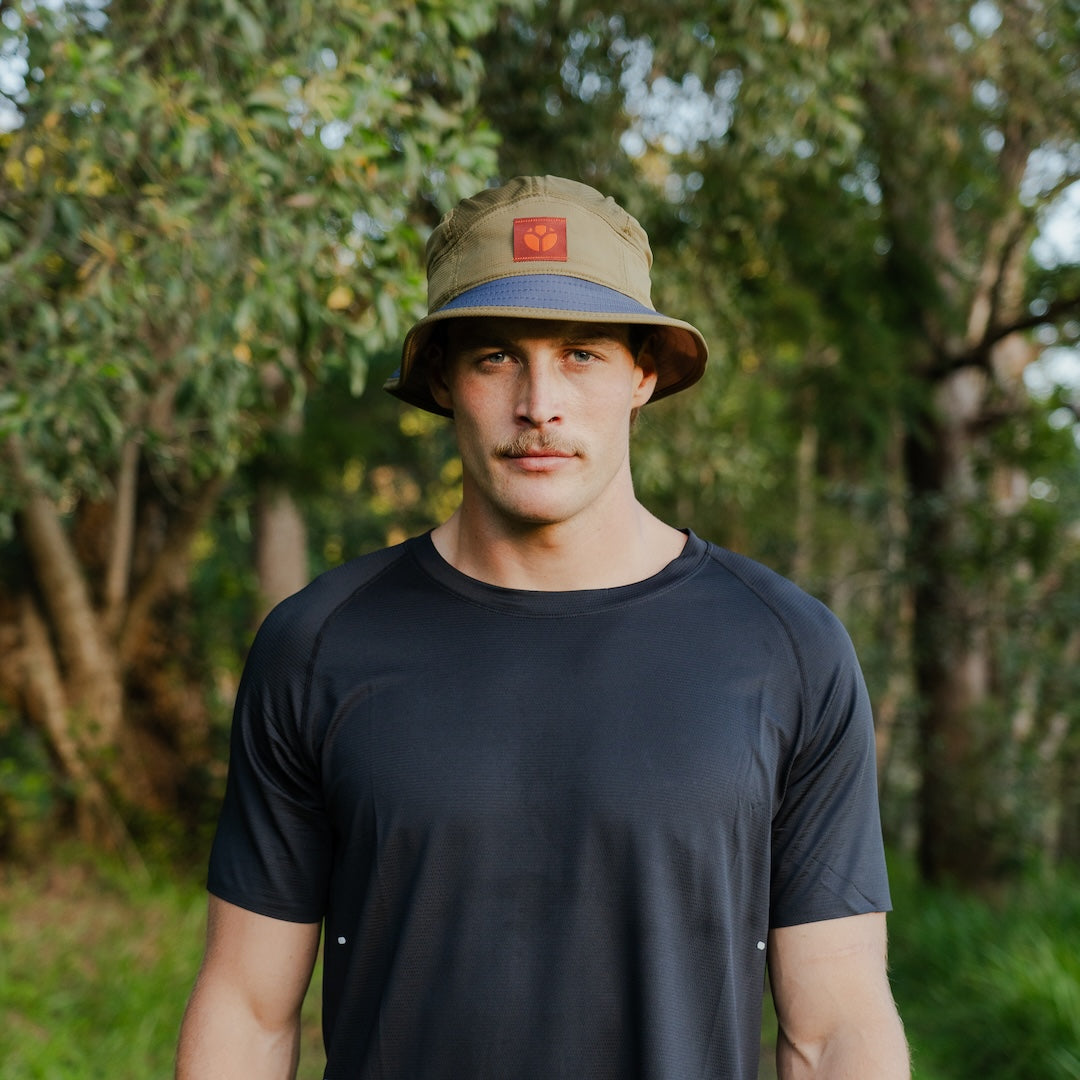 Runner wearing B-THICKET Bucket Hat outdoors