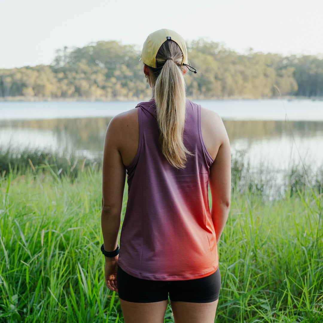 Runner wearing Women's S-EMBER Running Singlet outdoors