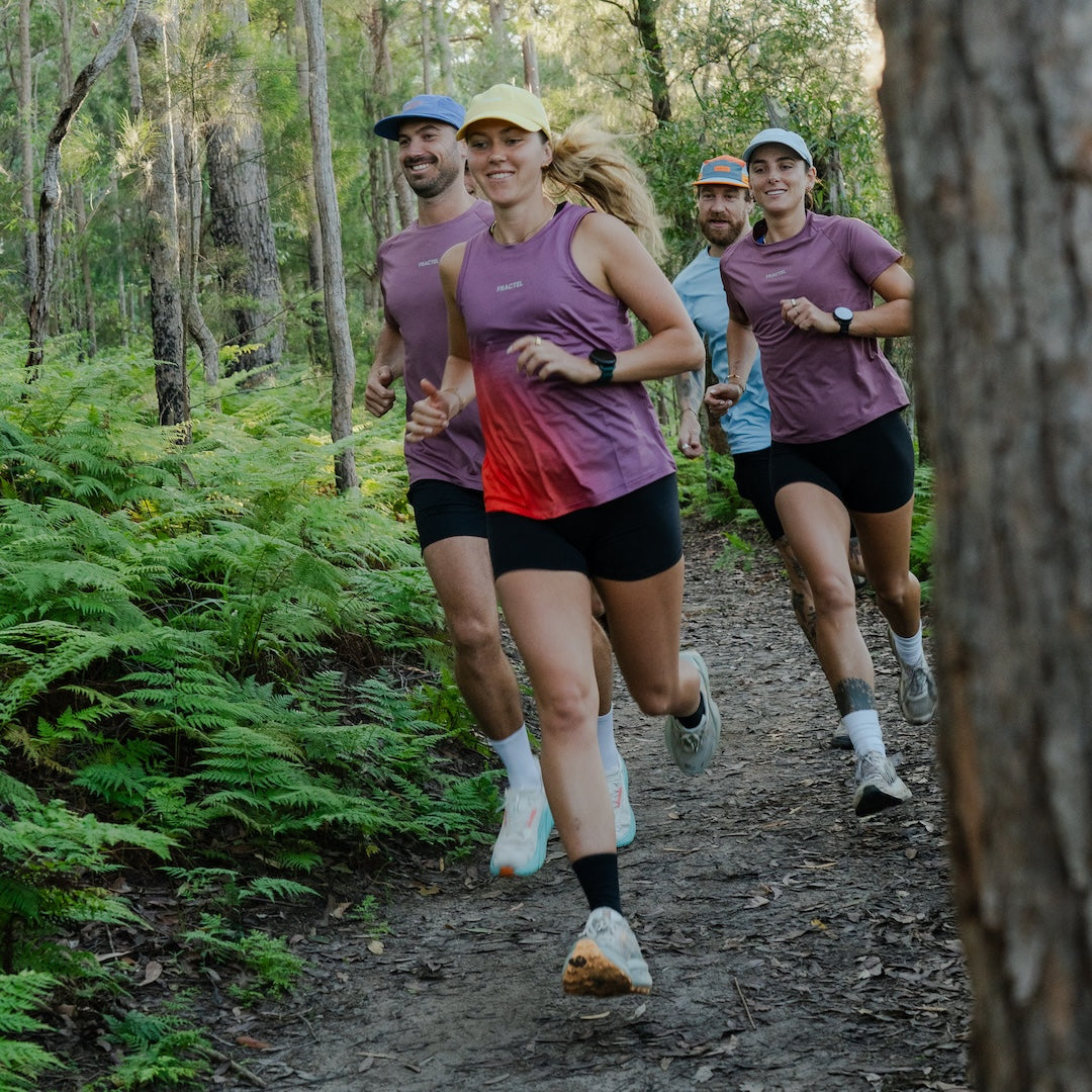 Runner wearing Women's S-EMBER Running Singlet outdoors